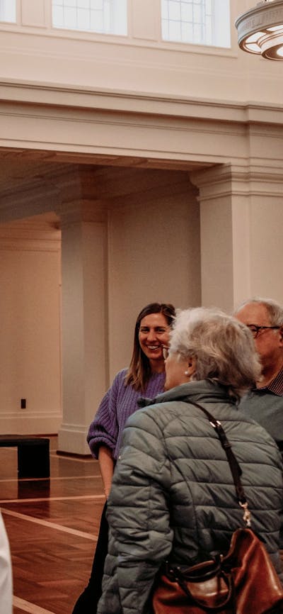 MoAD Experience Officer with a group of people gathered in King's Hall