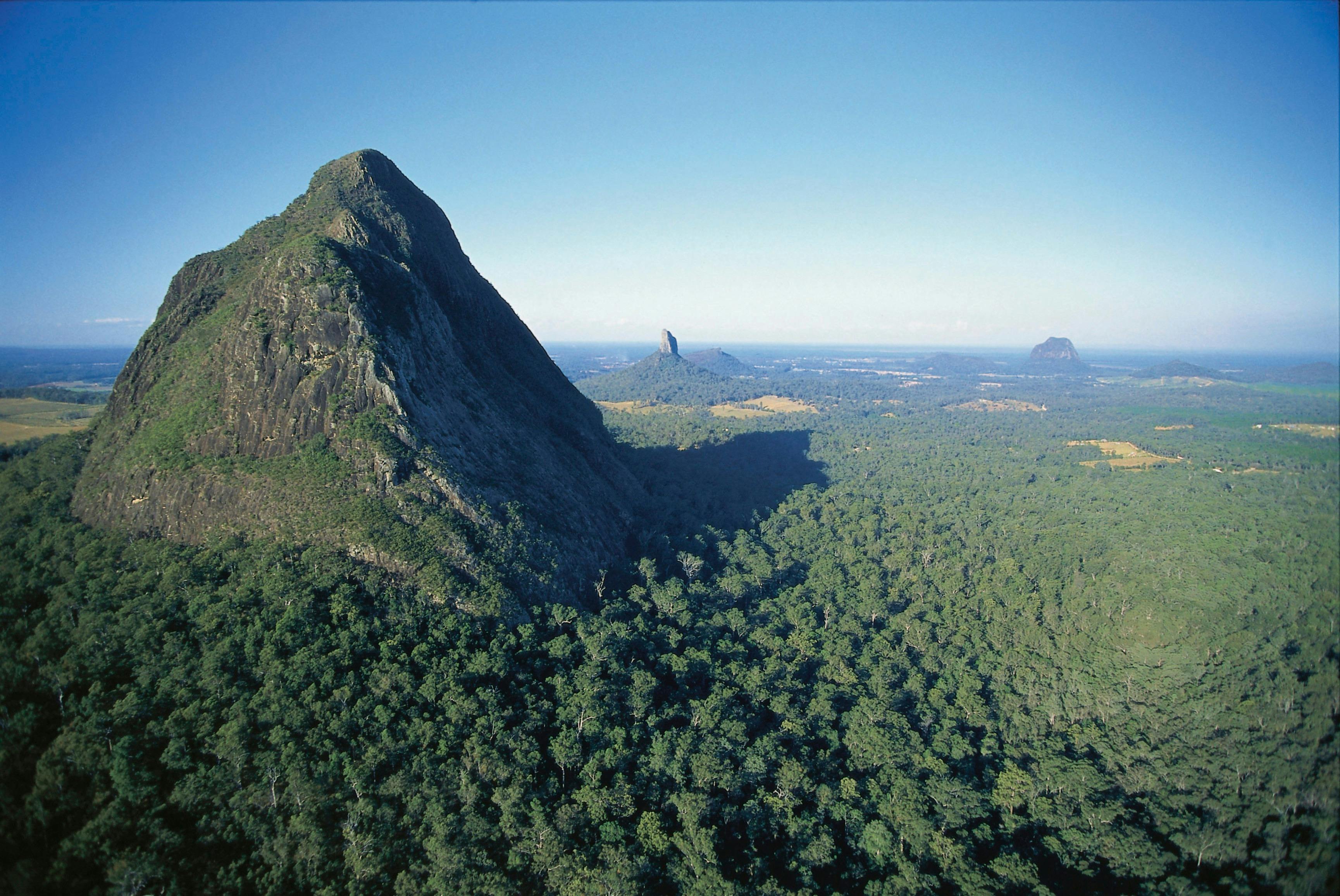 Tall mountain rises abruptly from surrounding coastal plain.