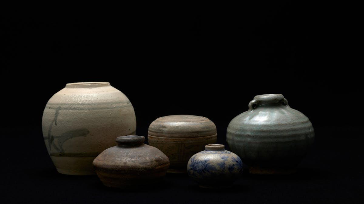 Selection of pottery objects dramatically lit Selection of pottery objects dramatically lit