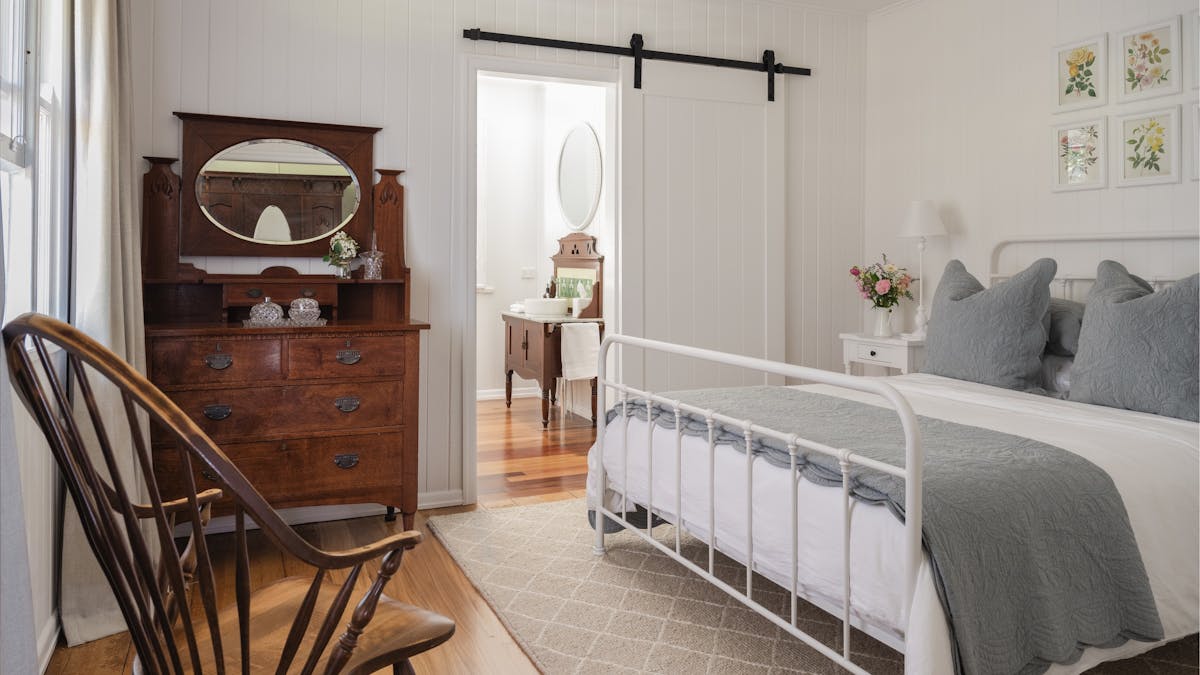 Queen Bed with heritage family furniture and luxury sheets.