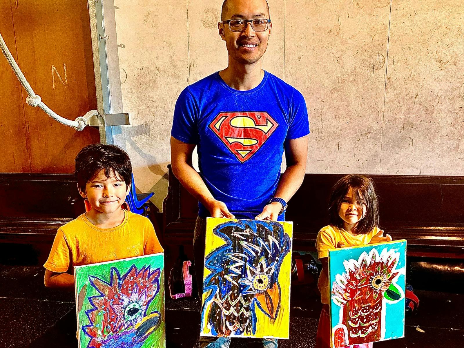 parent and children with their completed artworks