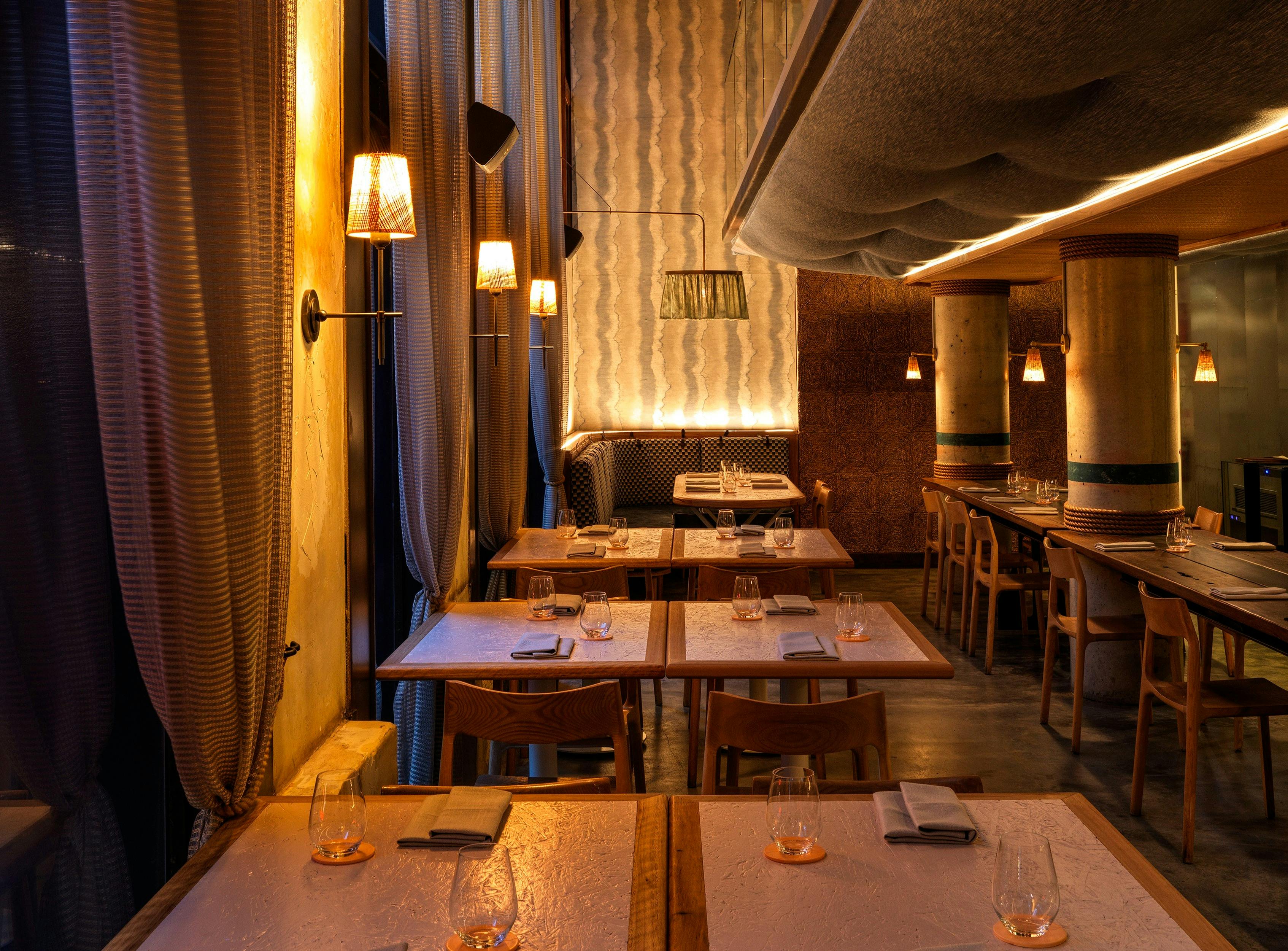 Moody photo of tables along the windows at Longshore