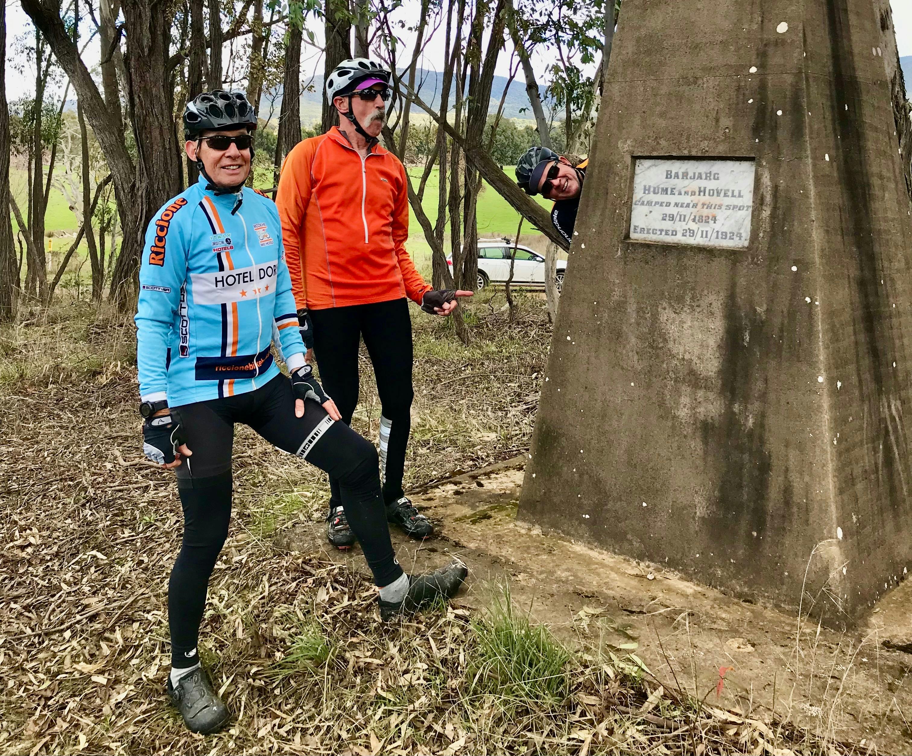 Three riders viewing monument at Barjarg