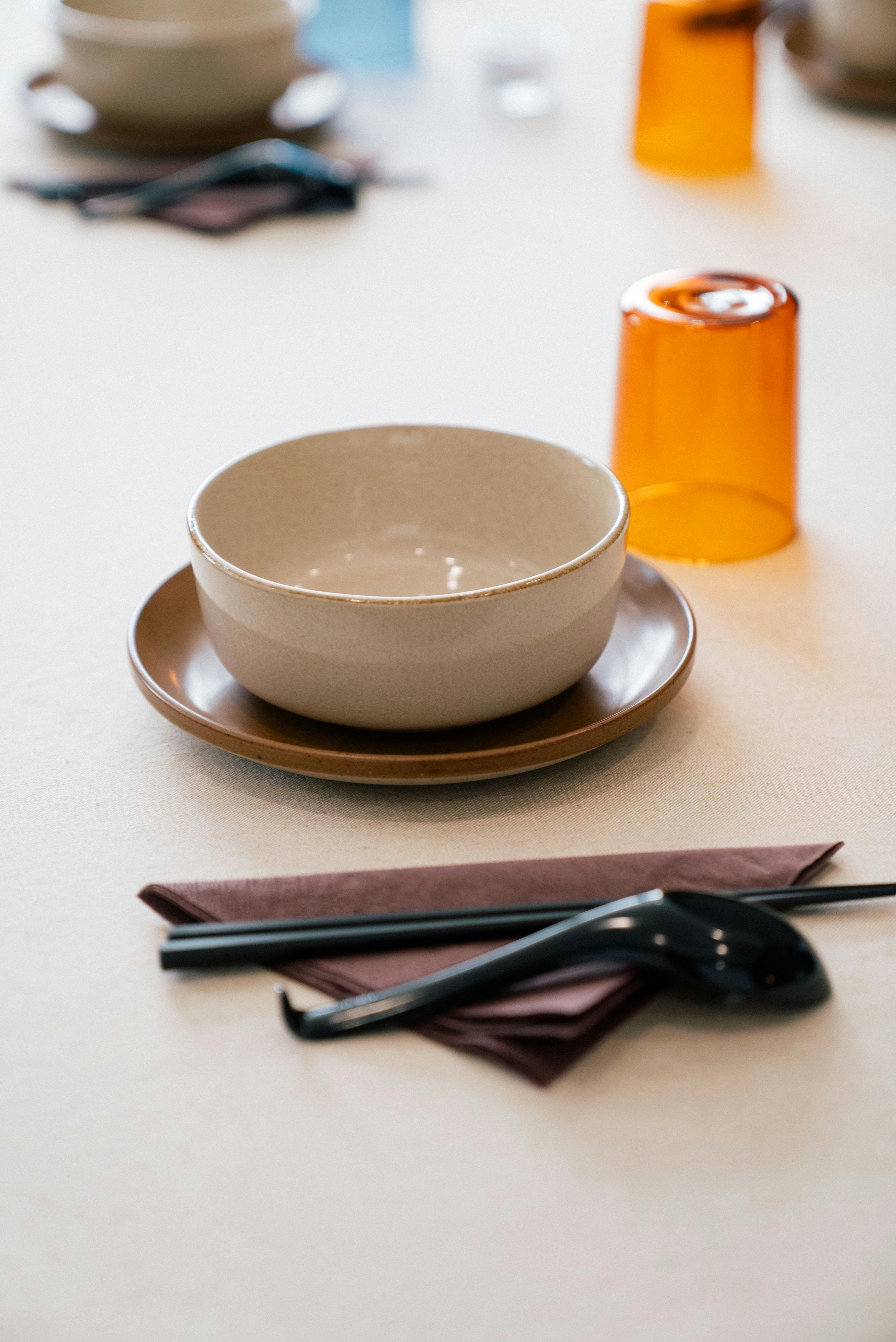 An elegant asian set table with chopsticks, soup spoons and bowls