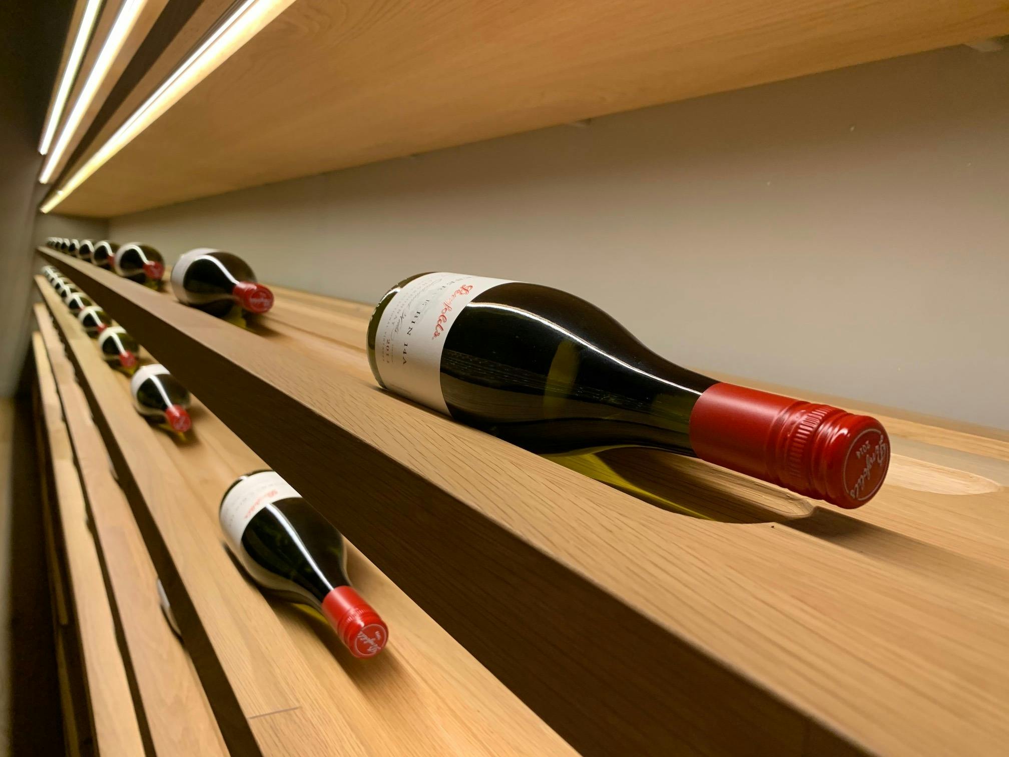 Wine bottles in Penfolds' cellar door laying on its side to keep the cork moist