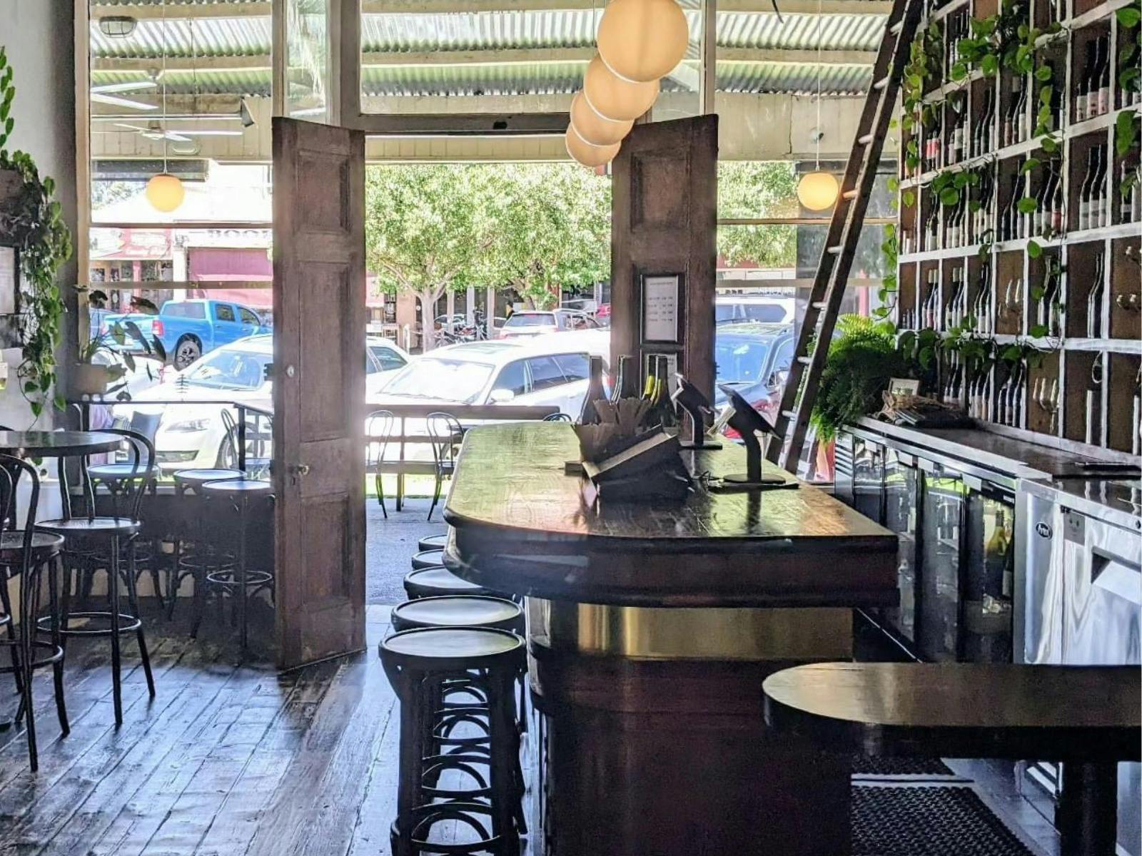 bar entryway with bar tables and stools