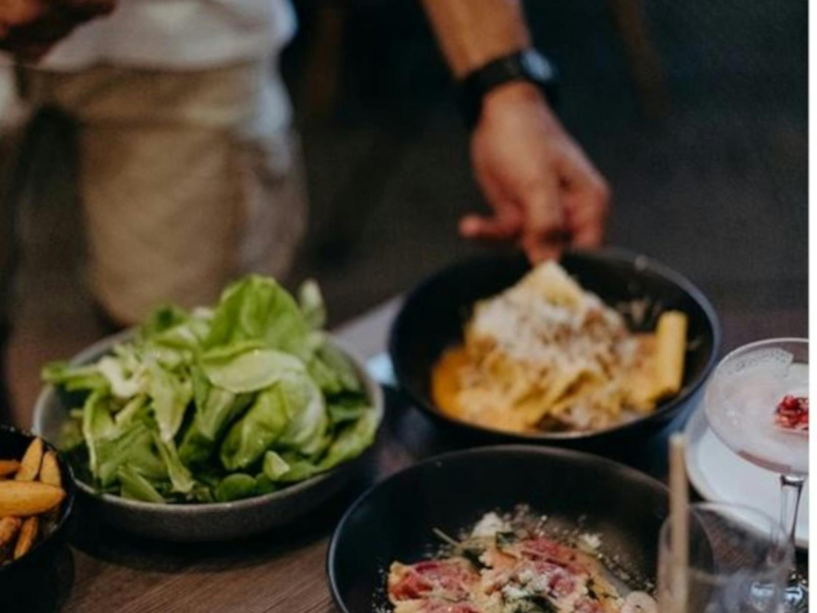 plates of delicious food being placed on a timber table