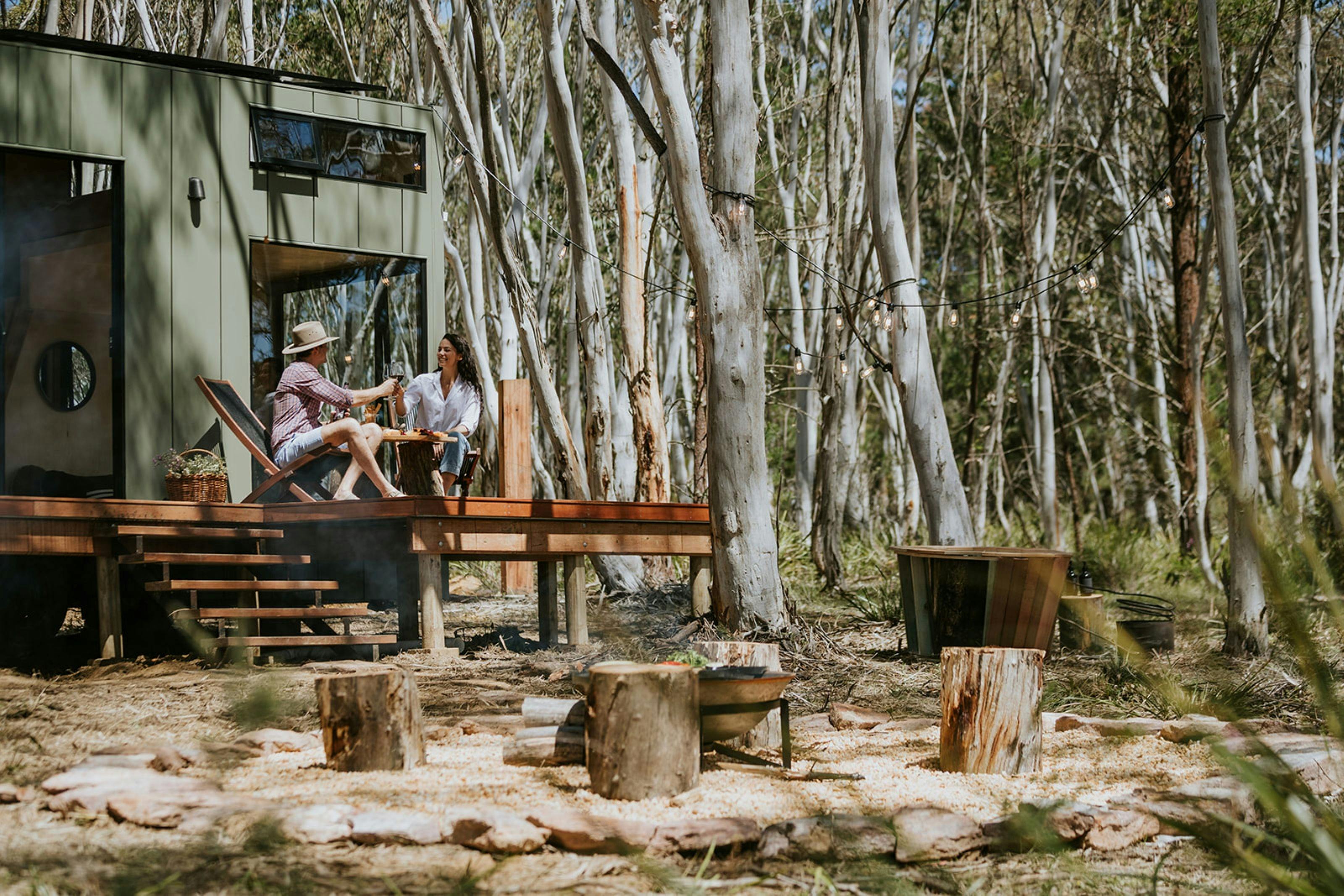 Cabin frontage showing deck overlooking outdoor bathtub