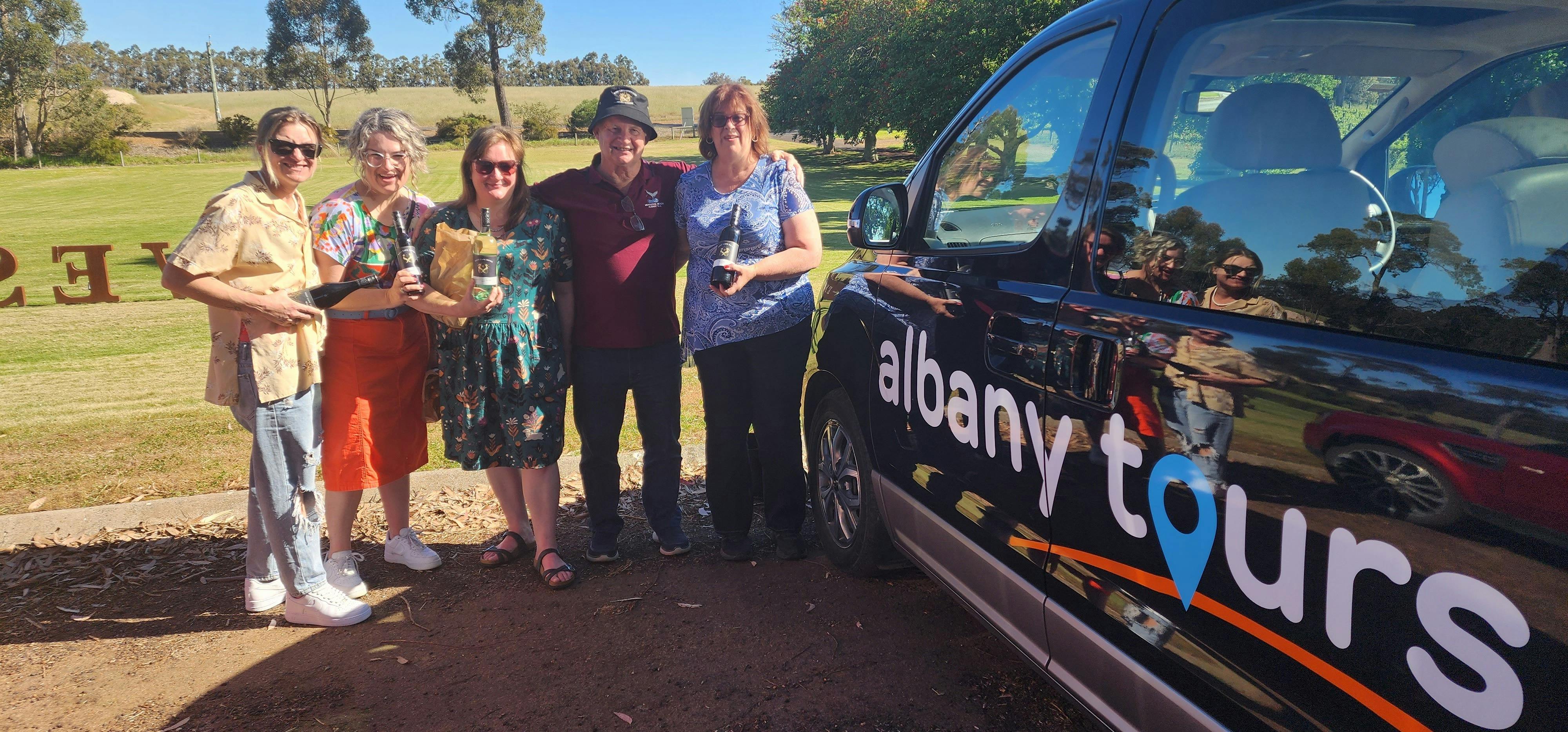 four people beside a van