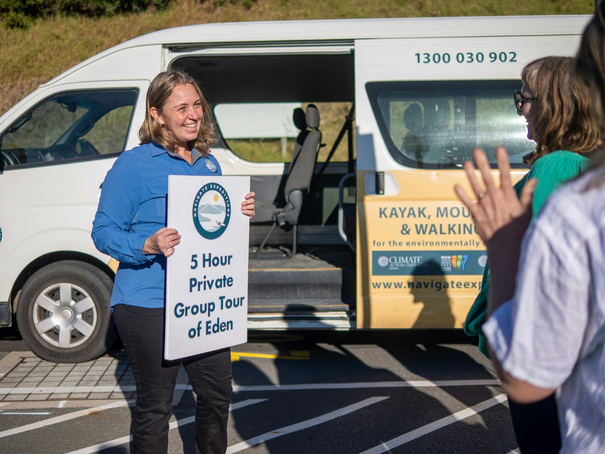 Navigate Guide holding sign waiting for guests at Port of Eden