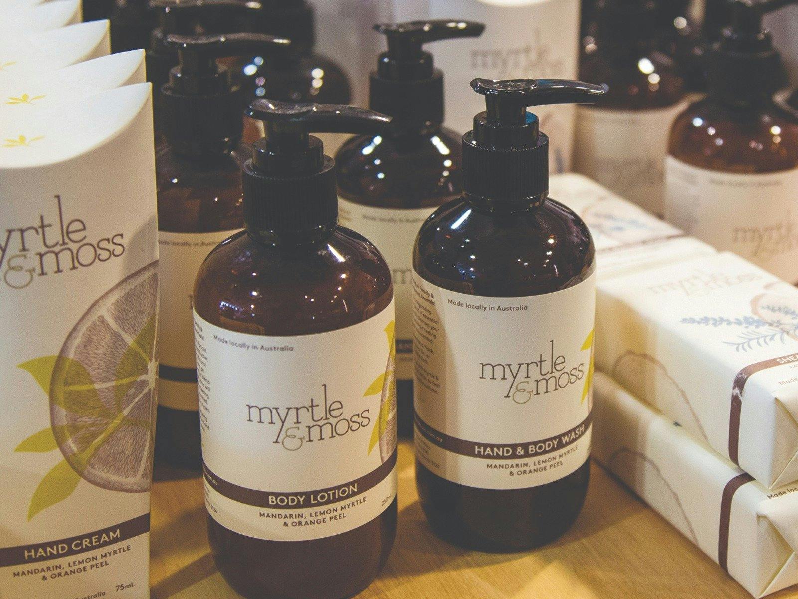Pump bottles of Hand & Body lotion and wash made by Myrtle and Moss brand