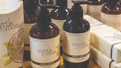 Pump bottles of Hand & Body lotion and wash made by Myrtle and Moss brand