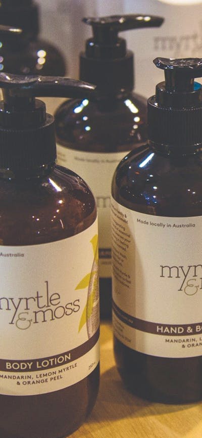 Pump bottles of Hand & Body lotion and wash made by Myrtle and Moss brand