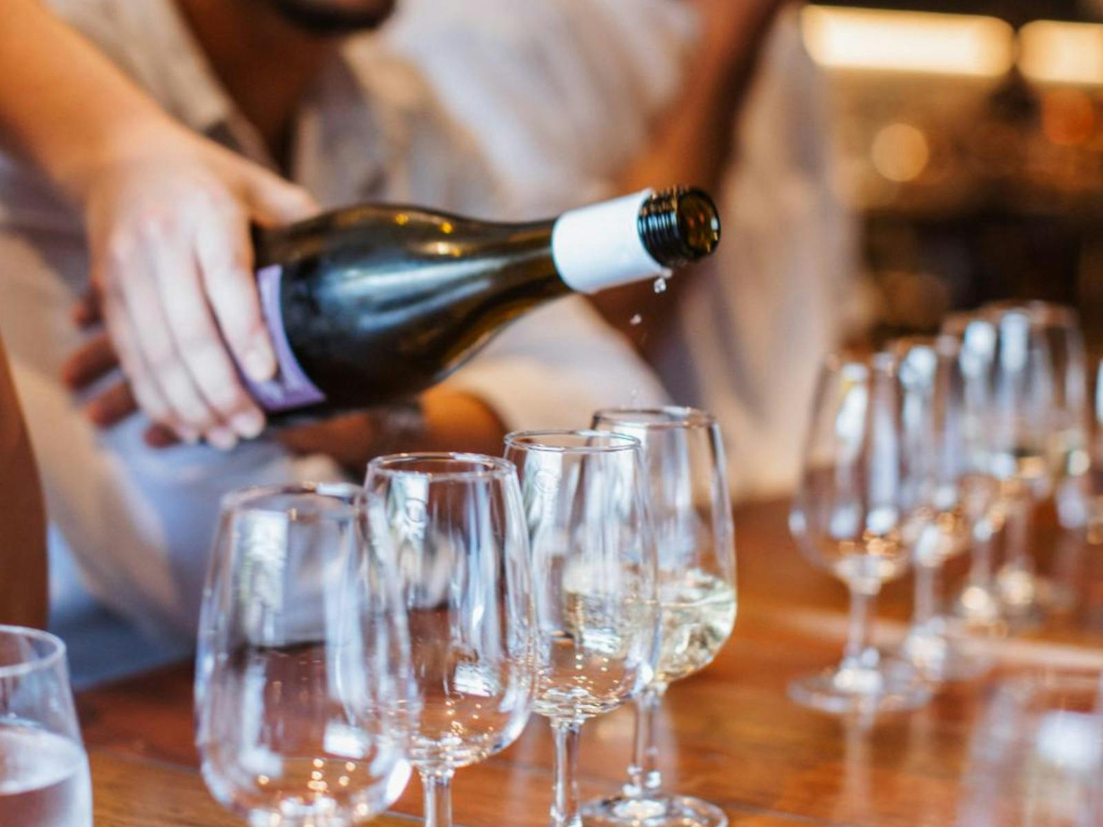 Wine being poured into tasting glasses