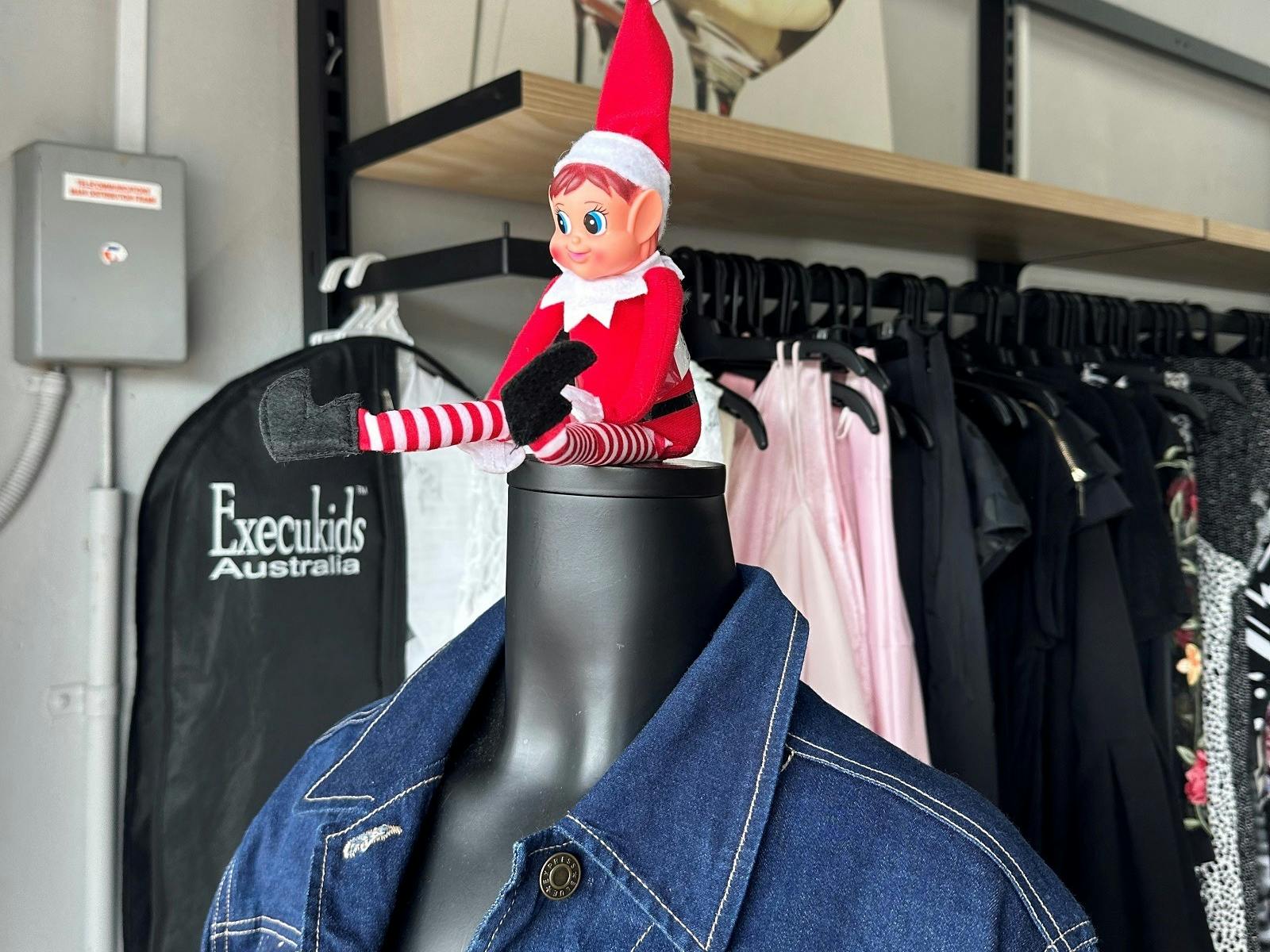 Cheeky elves hiding in shop windows