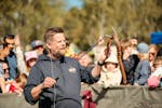 Snake handler showing festival attendees a snake