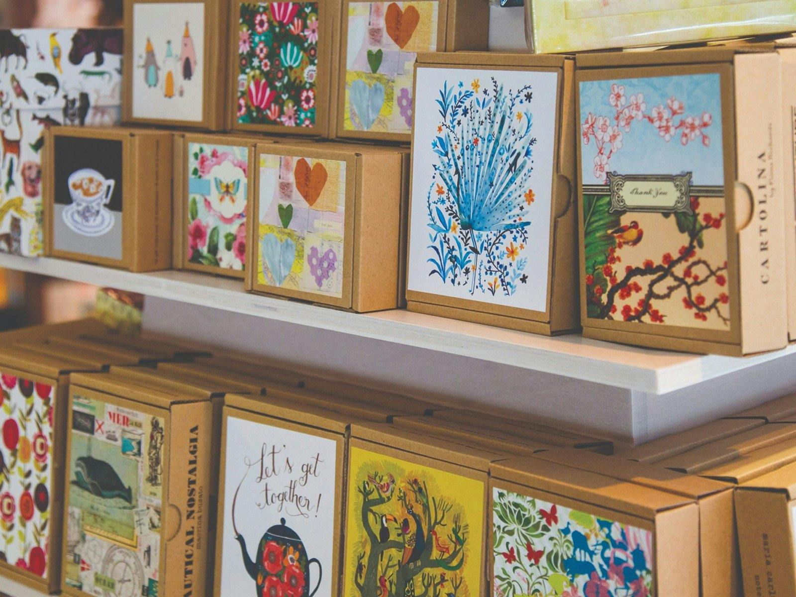 A selection of boxed notecards placed face-out on a display stand