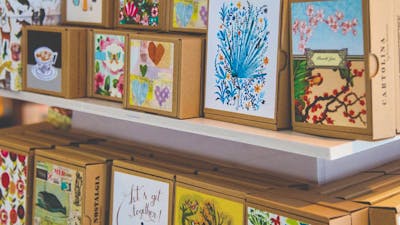 A selection of boxed notecards placed face-out on a display stand