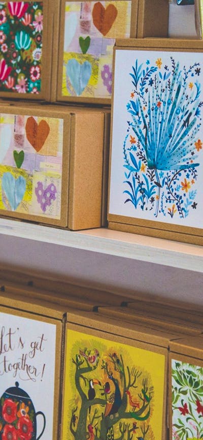 A selection of boxed notecards placed face-out on a display stand