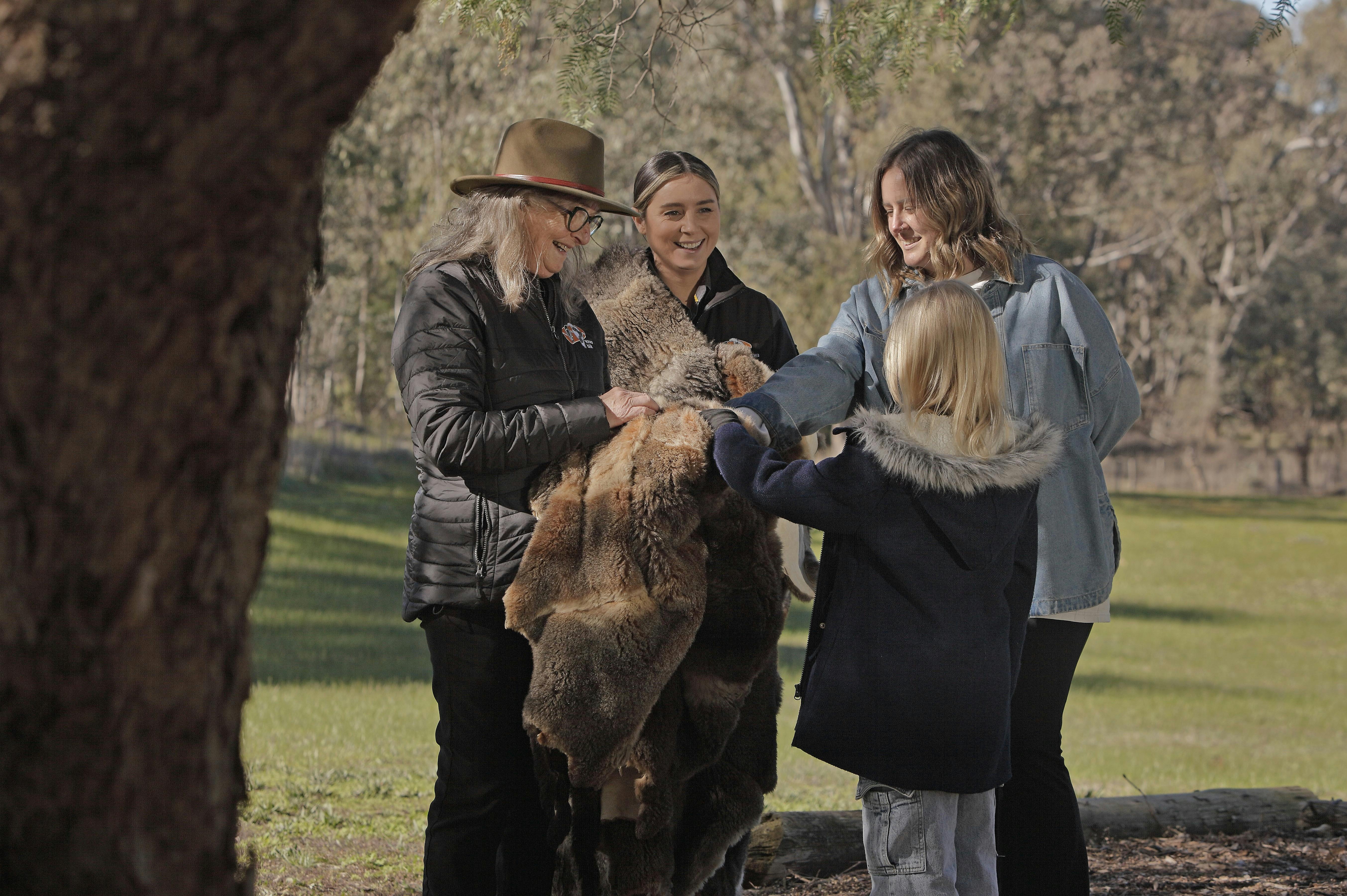 guides holding possum skin cloak