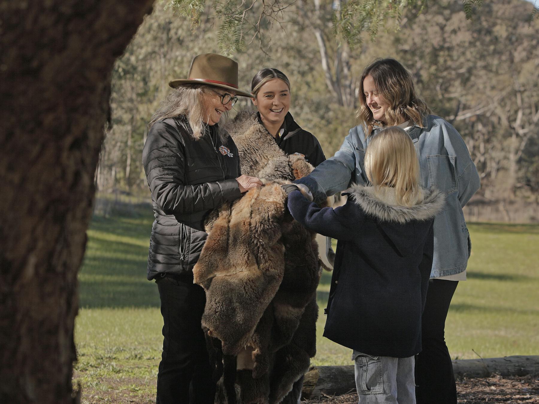 guides holding possum skin cloak
