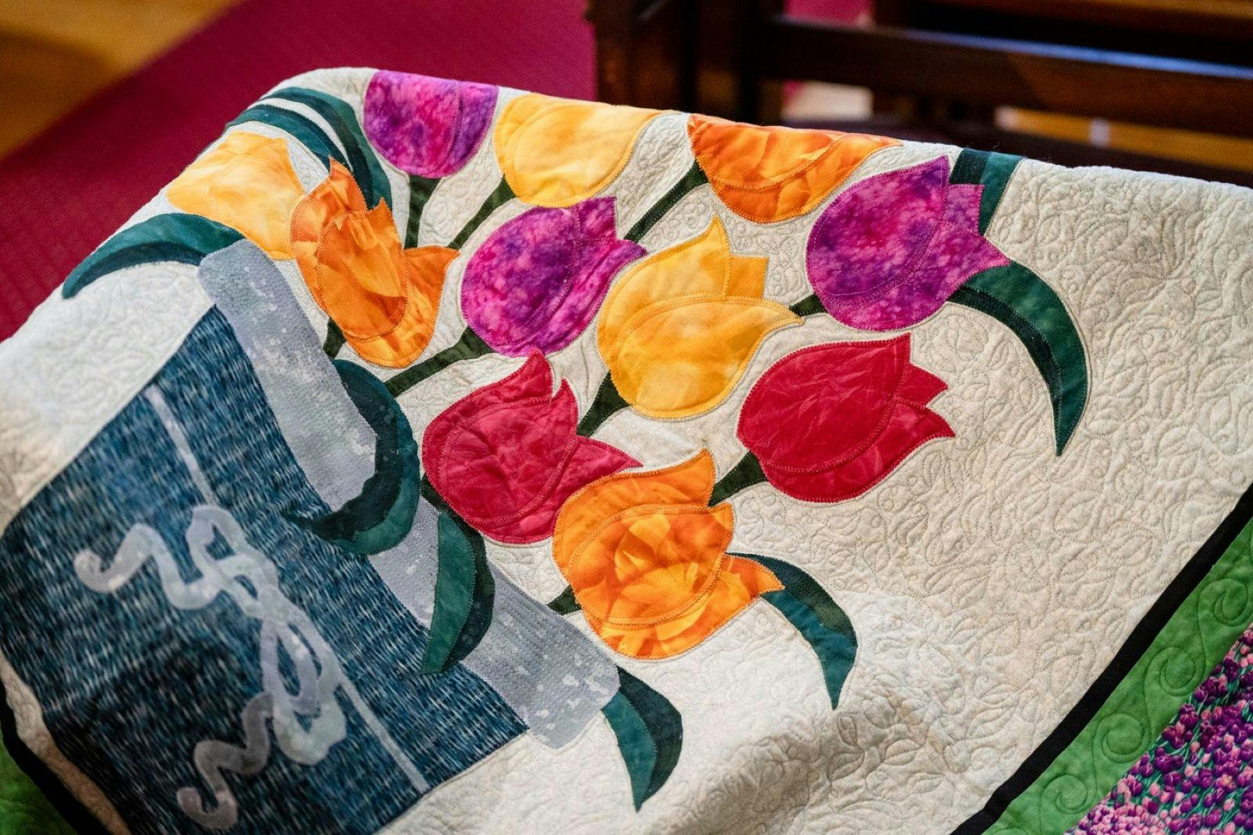 Quilt with coloured tulips embroided