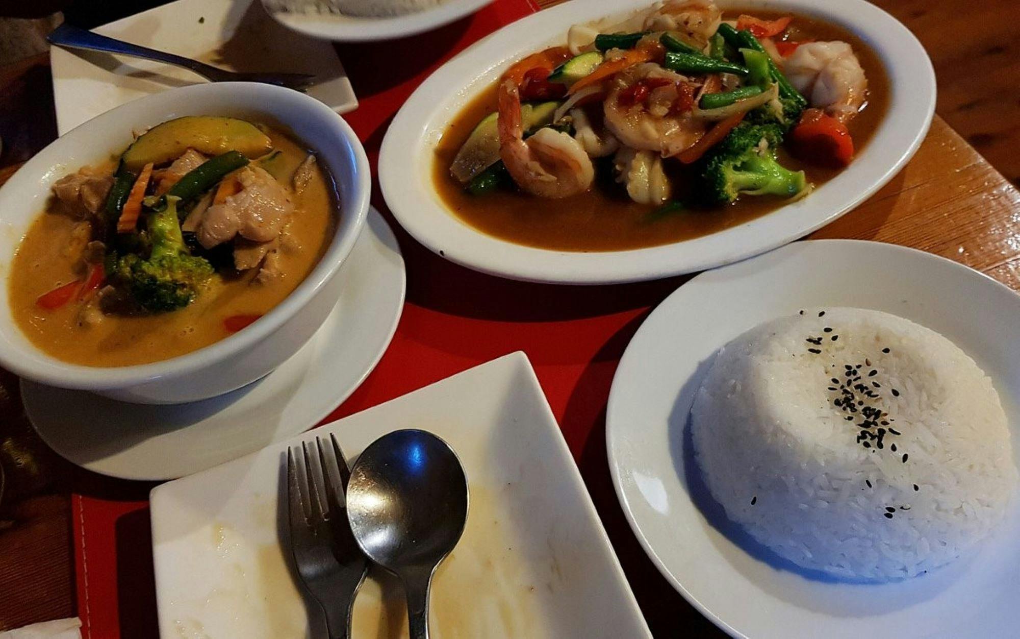Thai dishes on a red table cloth