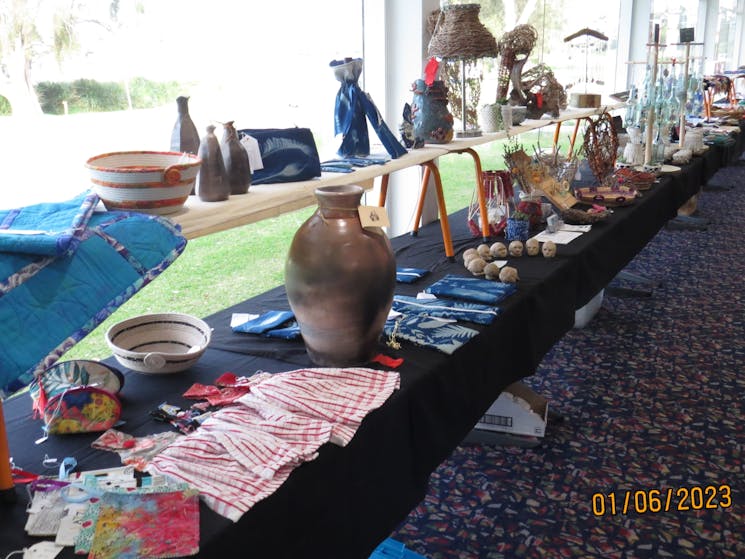 Display tables with a selection of craft entries in the 2023 Exhibition.