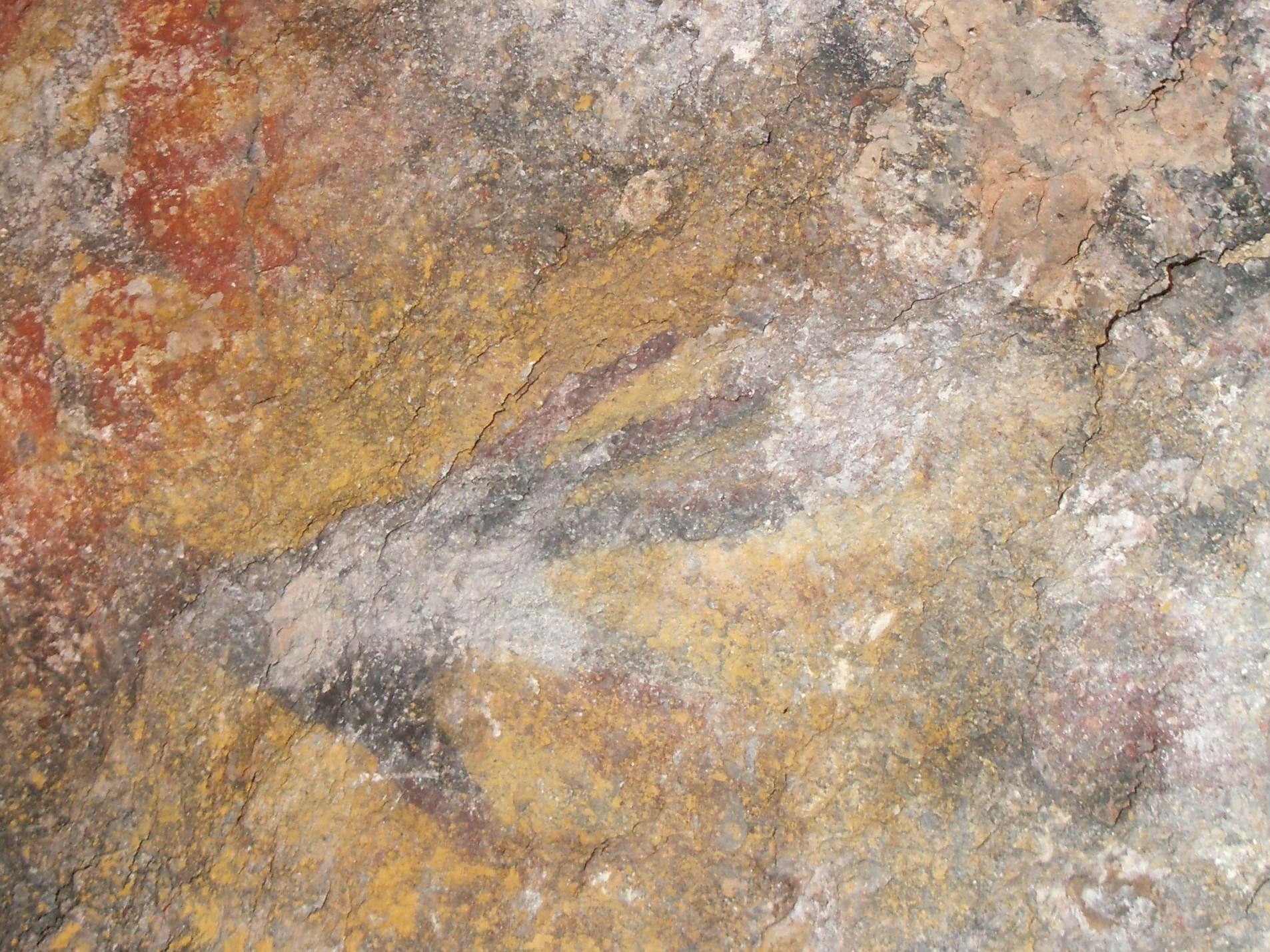 On a cave wall at Stratford, Aboriginal art, its colours and hand stencilling.