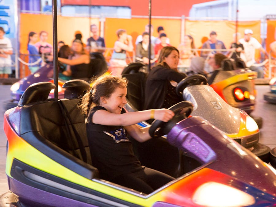 Child enjoying the dodgem cars at the carnival component of the event