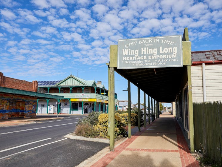 Side of Wing Hing Long buliding  with street running in front of building