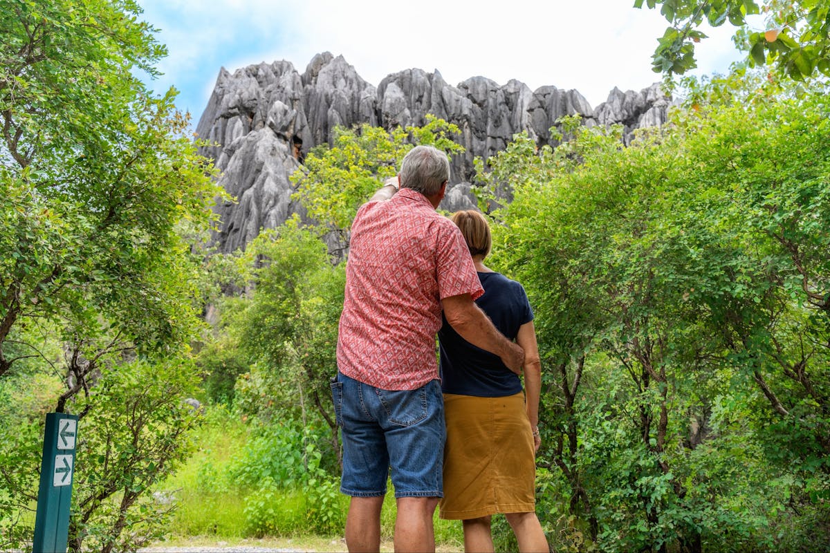 A man and woman embrace whilst viewing formations in Chillagoe-Mungana Caves National Park.