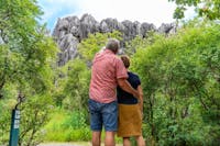 A man and woman embrace whilst viewing formations in Chillagoe-Mungana Caves National Park.