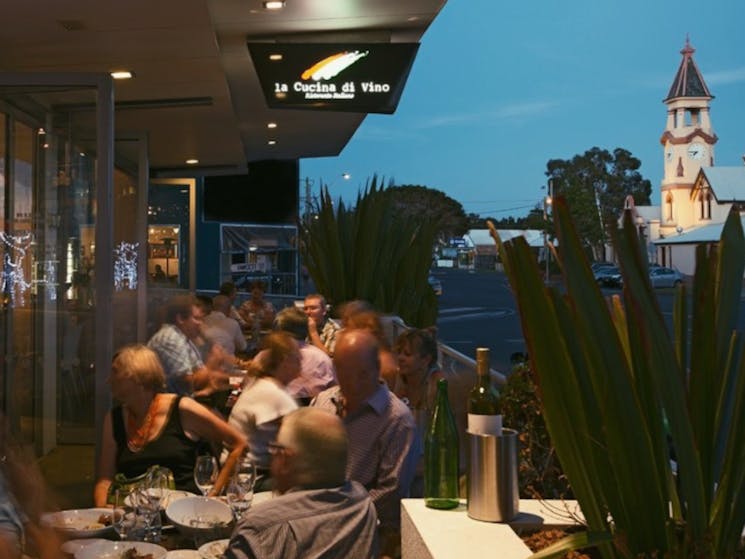 blurred image of diners eating outside at night