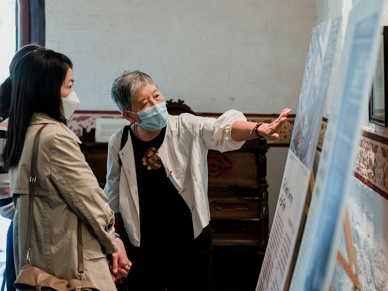 Two Chinese women view the exhibition