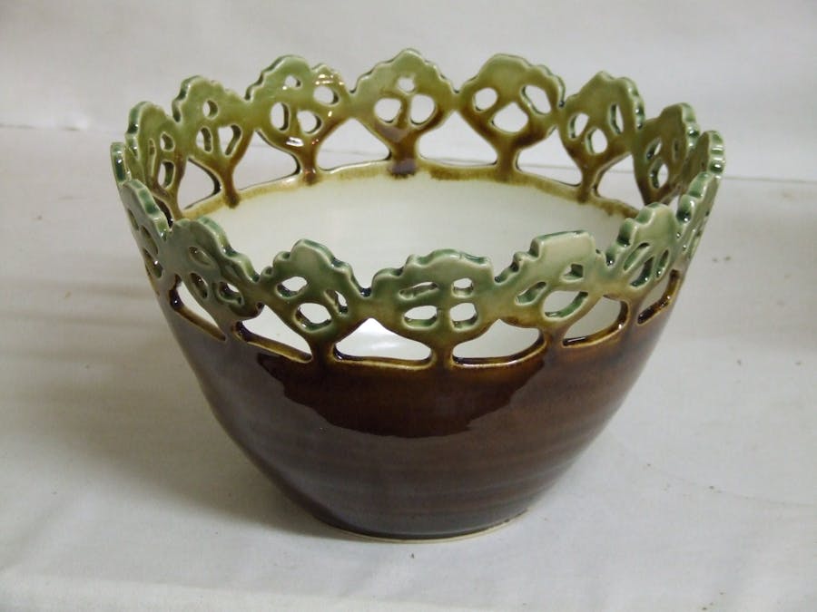Bowl with cutout decoration resembling treetops