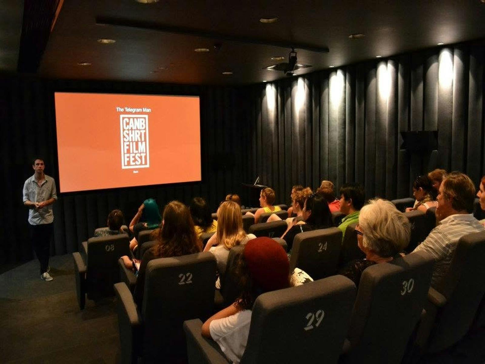 Movie Screen showing CSFF logo with audience watching