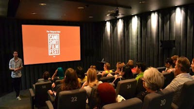 Movie Screen showing CSFF logo with audience watching