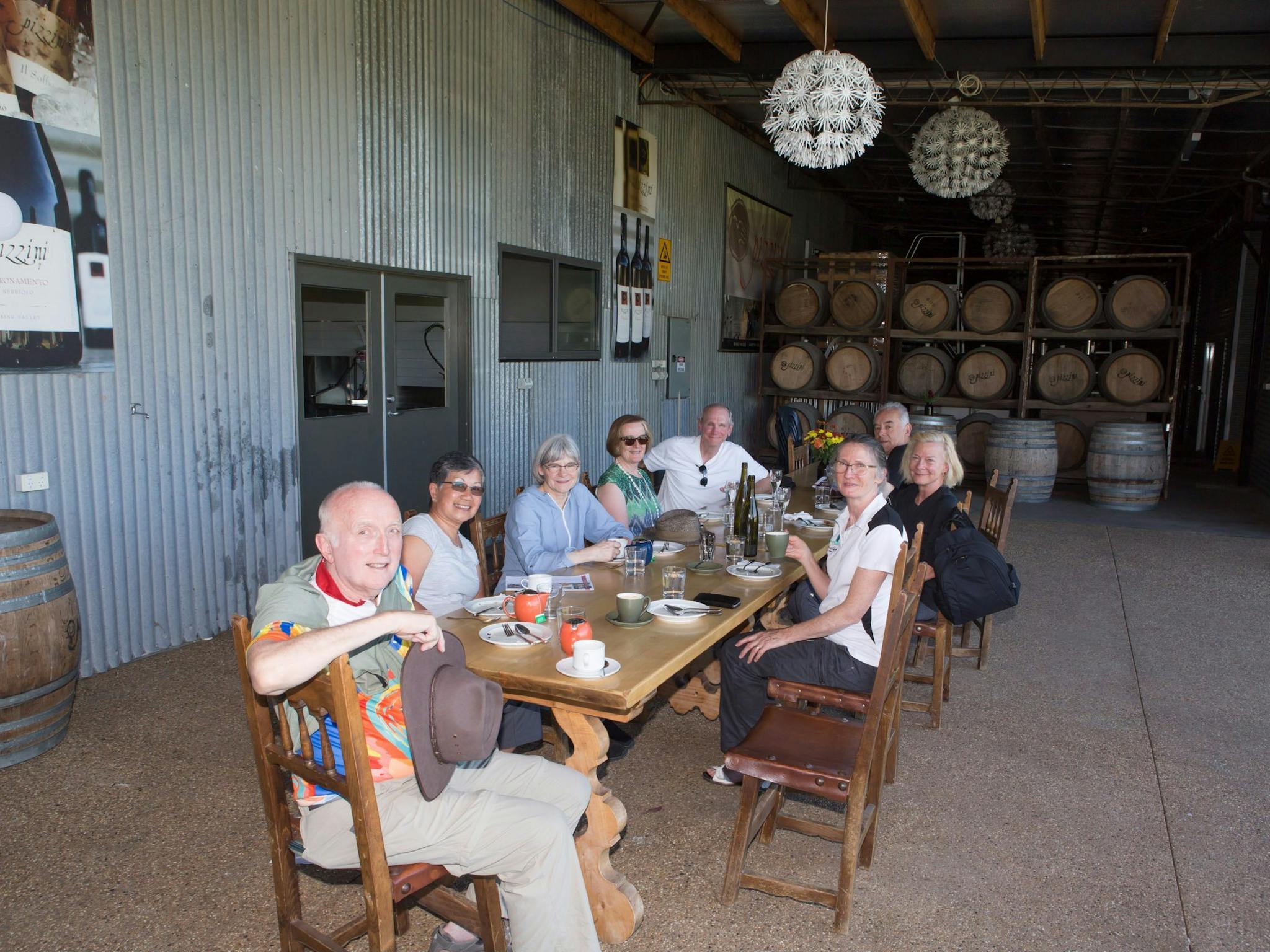 group tasting wine and coffee around a long table