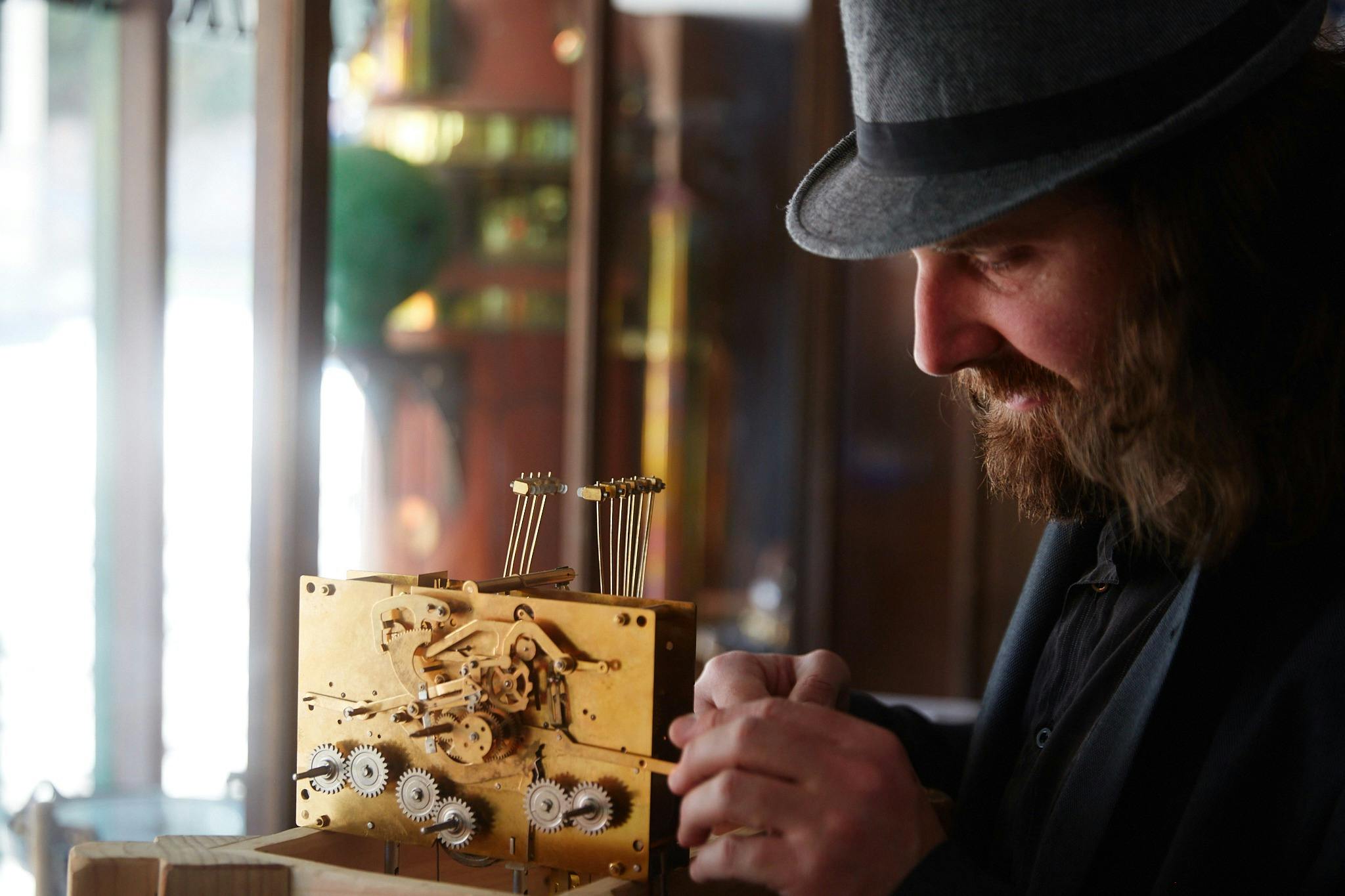 a man working on a metal contraption with gears