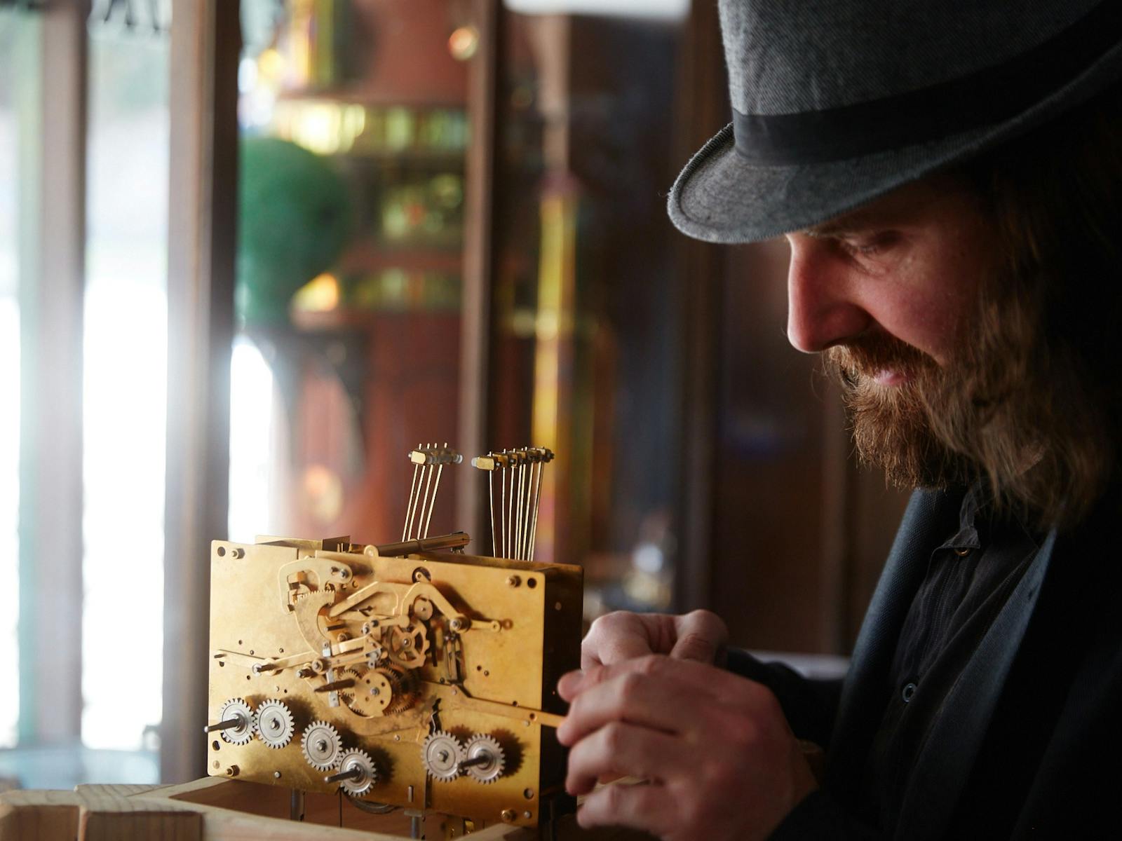 a man working on a metal contraption with gears