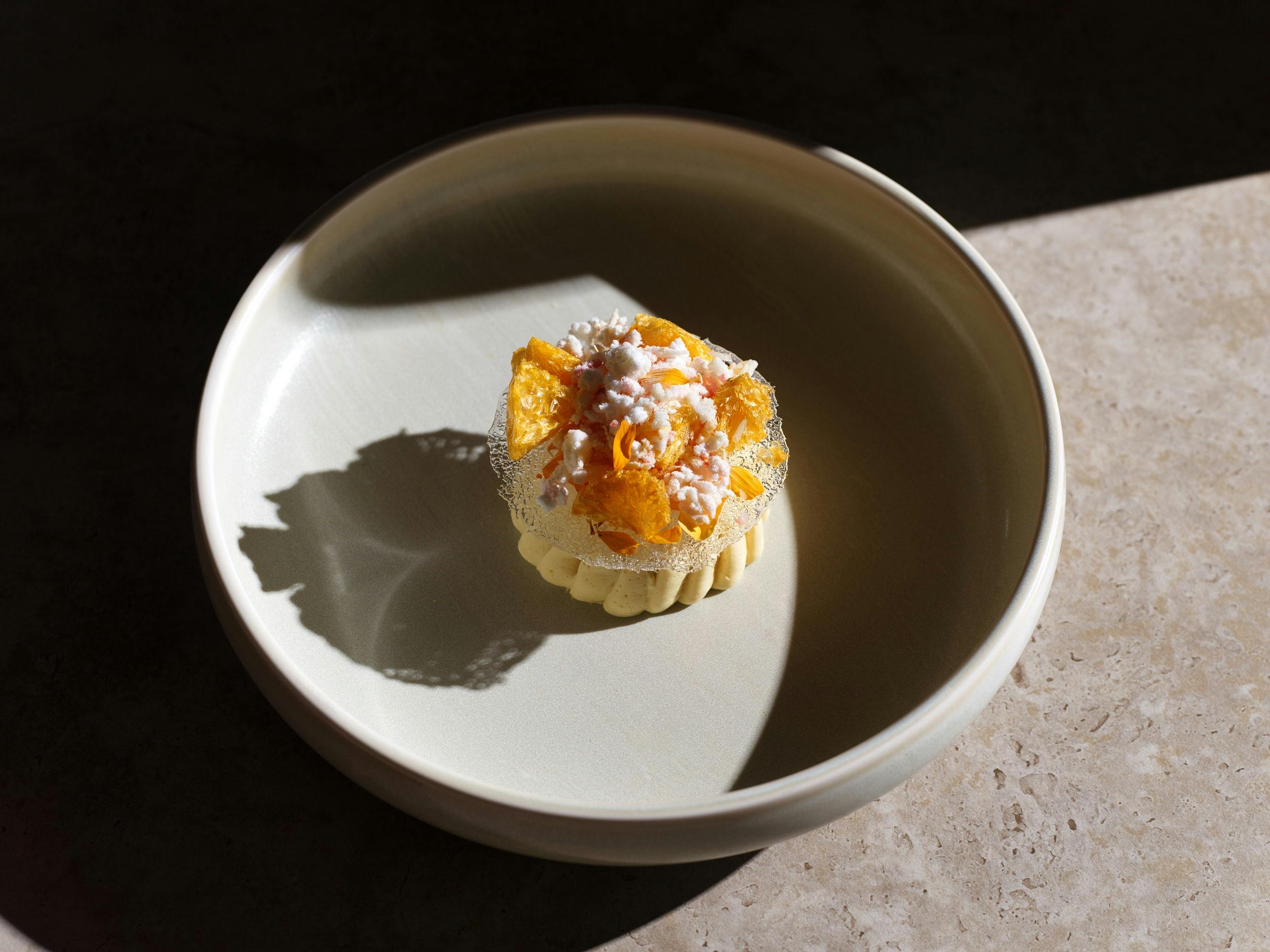 Signature dessert of Oborozuki: Sake baba Sudachi curd, citrus cells, marigold