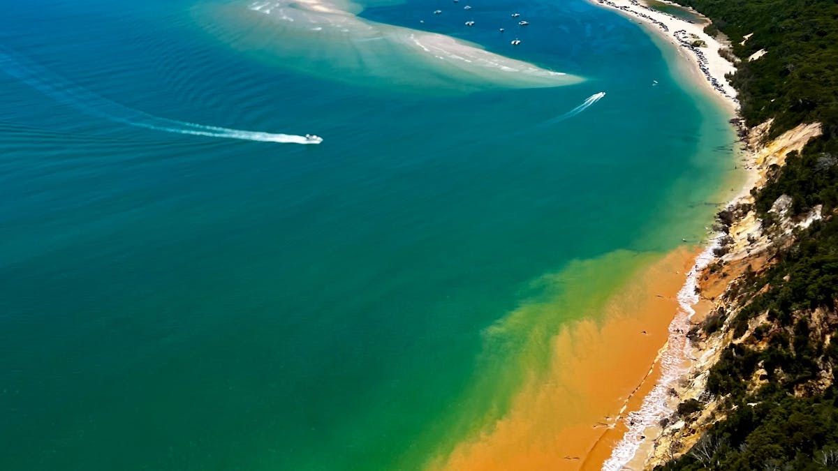 Coastline towards amazing Double Island Point from the famous coloured sands
