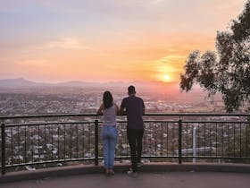 Photograph of couple standing at the lookout enjoying the lovely sunset