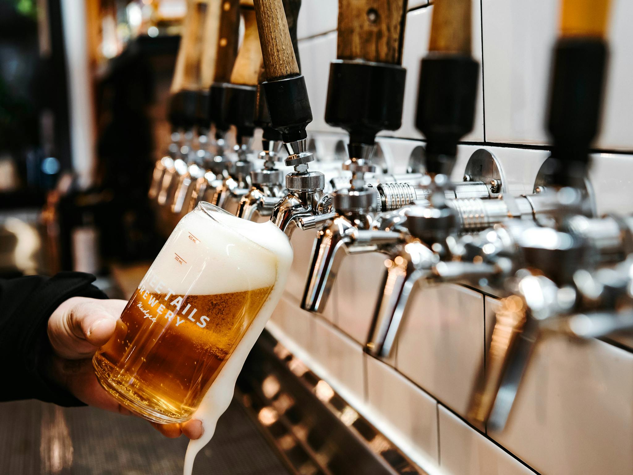 A glass of beer being poured