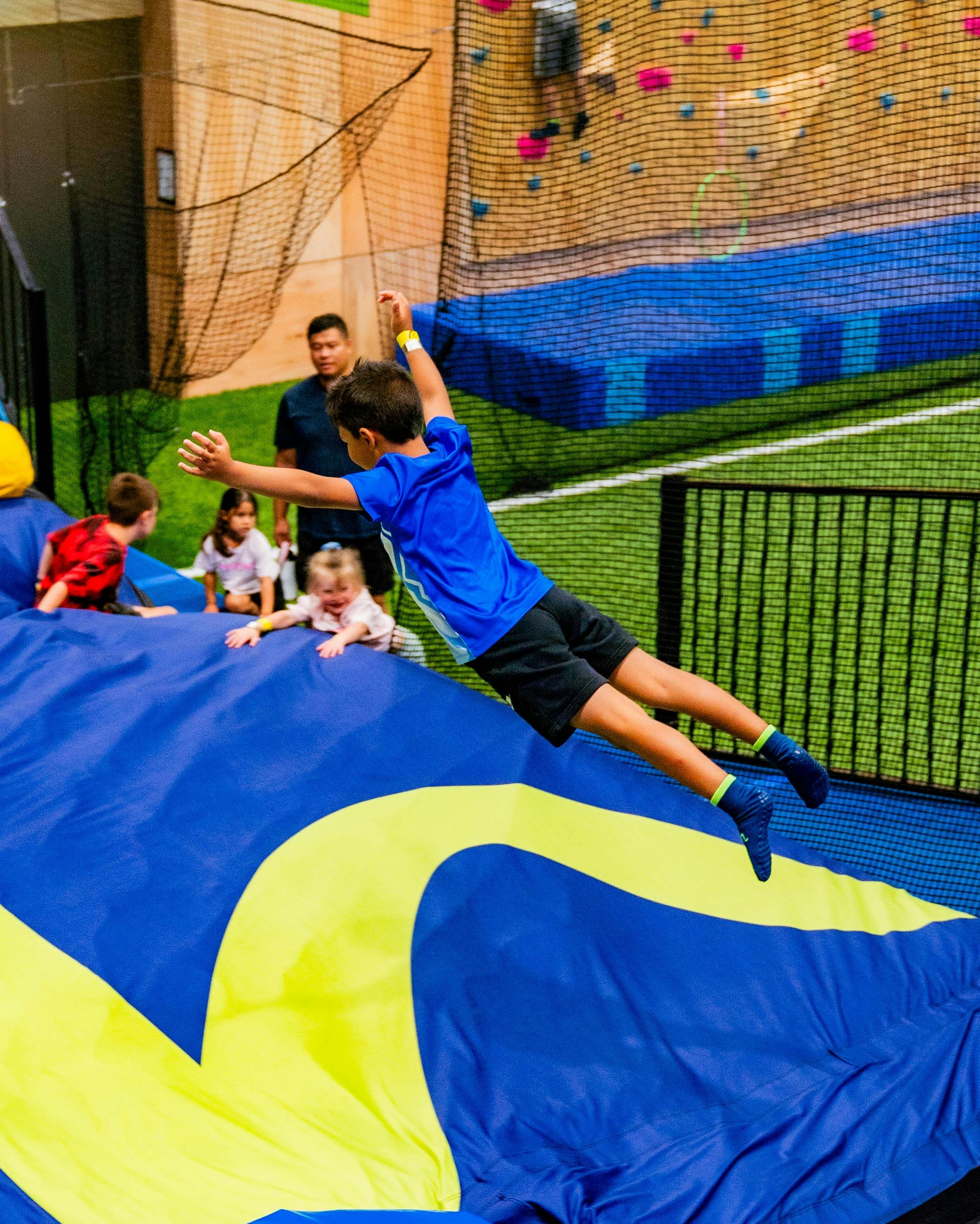 Child jumping into airbag from trampoline