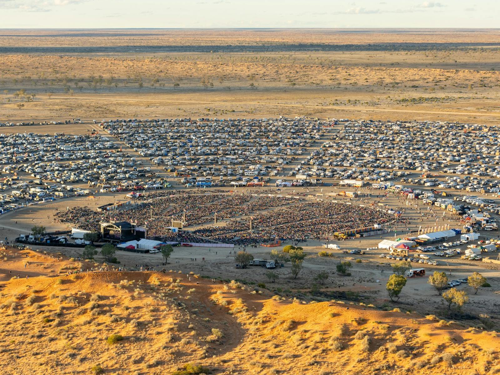 Aerial view of Birdsville Big Red Bash campground stretching across the Simpson Desert, Queensland Aerial view of Birdsville Big Red Bash campground stretching across the Simpson Desert, Queensland