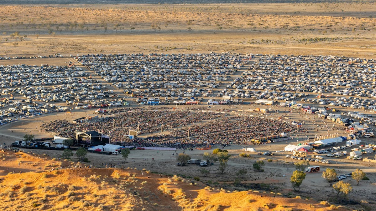 Aerial view of Birdsville Big Red Bash campground stretching across the Simpson Desert, Queensland