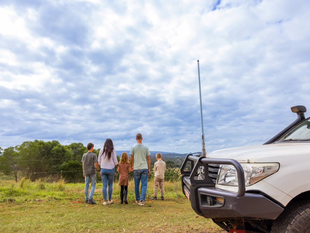 A family with their car at the lookout