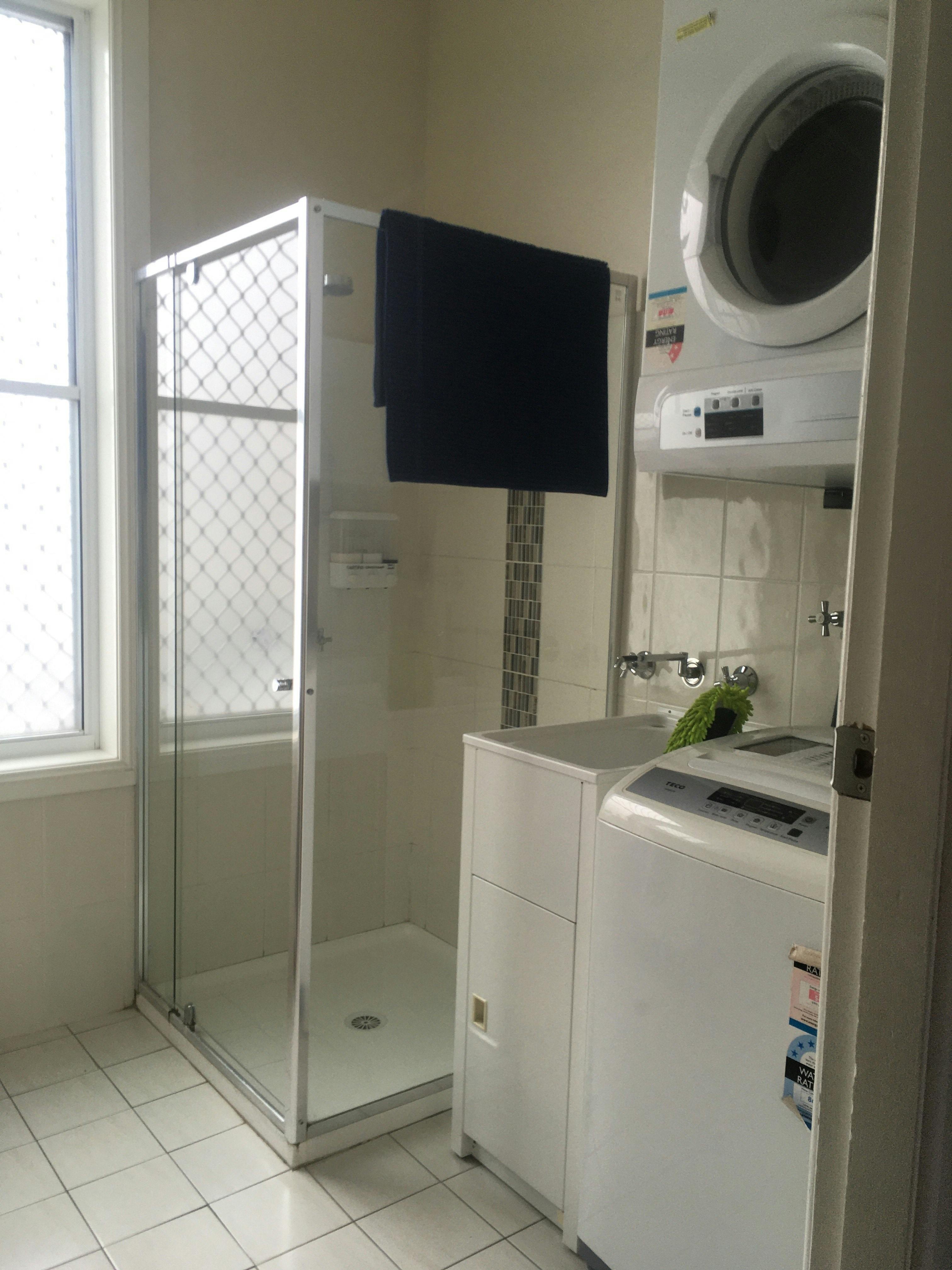 Bathroom Showing Shower, Washing machine & Dryer